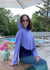 Woman in a super soft sunproof sun safe upf 50 + hoodie, periwinkle color wearing big sunglasses looking happy